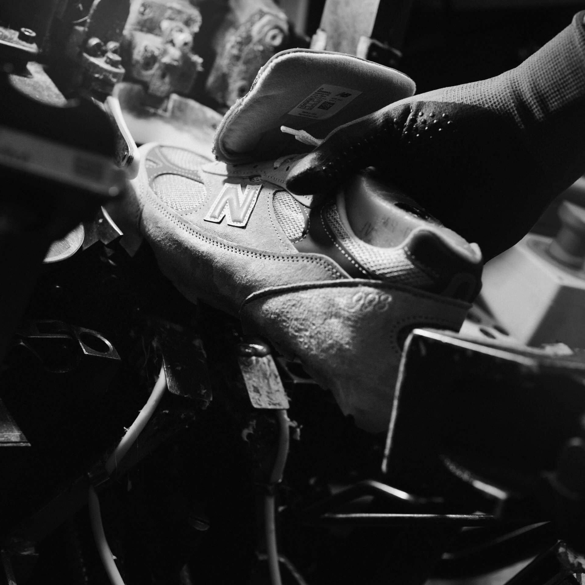 A close up of image of a person putting a shoe into a machine.