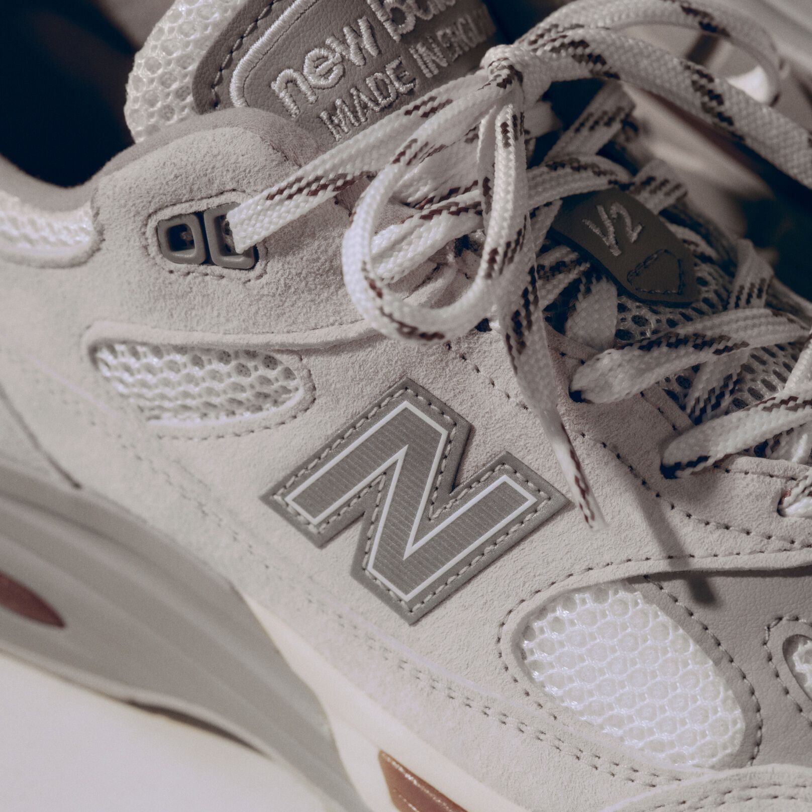 A close-up detailed view of a pair of New Balance Made in UK sneakers. 