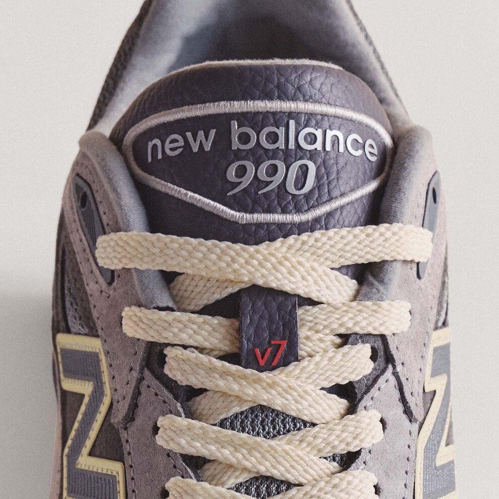 A close up image of the tongue of a 990v7 sneaker.